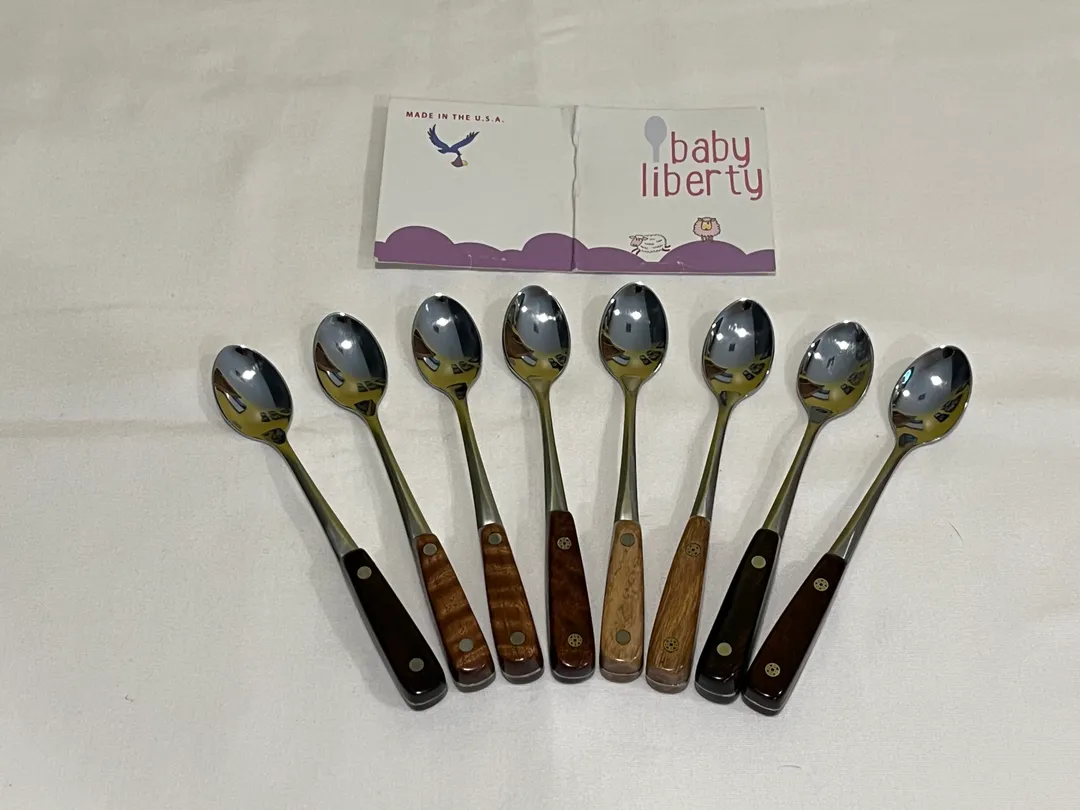 Eight Baby Liberty Spoons with various wood types and nickel silver or mosaic pins...The spoons are made of 18/10 stainless steel (no coating) and are 5-5/8" long...made in USA