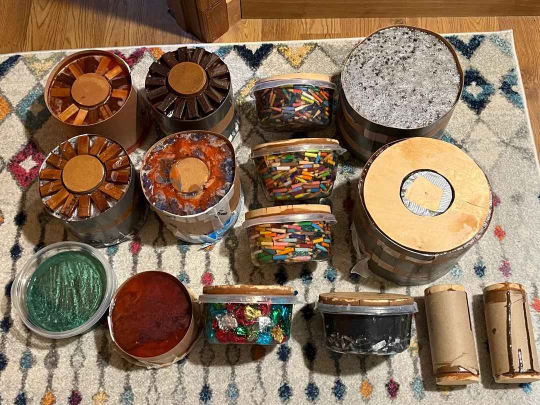 (4) block bowls, (3) colored pencil cut offs bowls, (2) large colored pencil bowls, ironwood bowl (green), mesquite burl bowl (red), colored aluminum foil and a silver aluminum foil bowl and (2) colored pencil cylinders for candle sticks